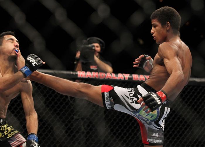 LAS VEGAS, NV - FEBRUARY 04: Alex Caceres (right) kicks Edwin Figueroa during the UFC 143 event at Mandalay Bay Events Center on February 4, 2012 in Las Vegas, Nevada. (Photo by Josh Hedges/Zuffa LLC/Zuffa LLC via Getty Images) *** Local Caption *** Ale