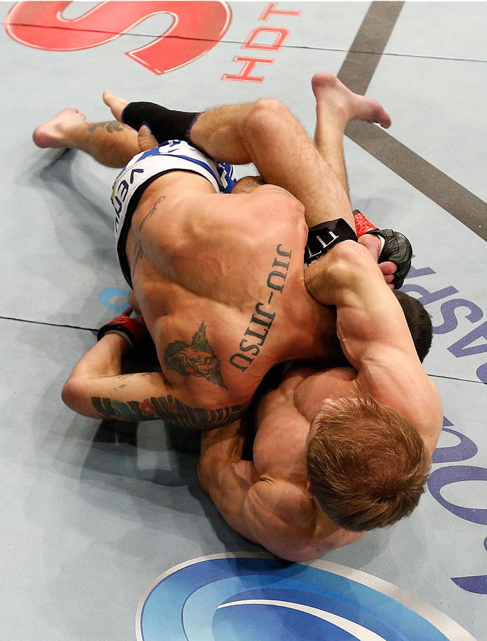 BELO HORIZONTE, BRAZIL - SEPTEMBER 04: (R-L) Ali Bagautinov attempts a guillotine choke against Marcos Vinicius in their flyweight fight during the UFC on FOX Sports 1 event at Mineirinho Arena on September 4, 2013 in Belo Horizonte, Brazil. (Photo by Jo