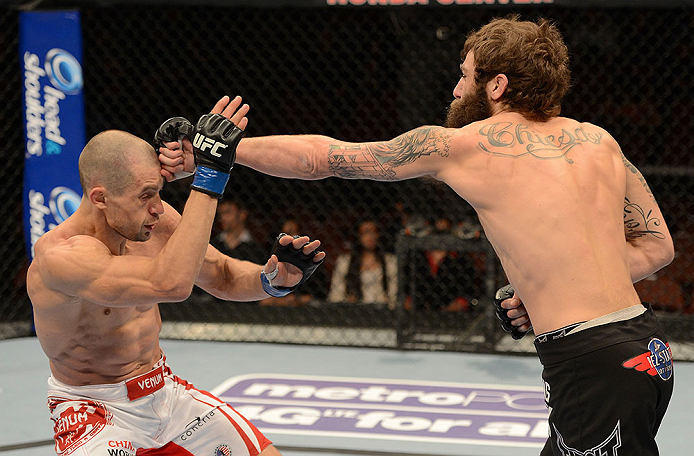 ANAHEIM, CA - FEBRUARY 23: (R-L) Michael Chiesa punches Anton Kuivanen in their lightweight bout during UFC 157 at Honda Center on February 23, 2013 in Anaheim, California. (Photo by Donald Miralle/Zuffa LLC/Zuffa LLC via Getty Images) *** Local Caption