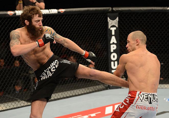 ANAHEIM, CA - FEBRUARY 23: (L-R) Michael Chiesa kicks Anton Kuivanen in their lightweight bout during UFC 157 at Honda Center on February 23, 2013 in Anaheim, California. (Photo by Donald Miralle/Zuffa LLC/Zuffa LLC via Getty Images) *** Local Caption *