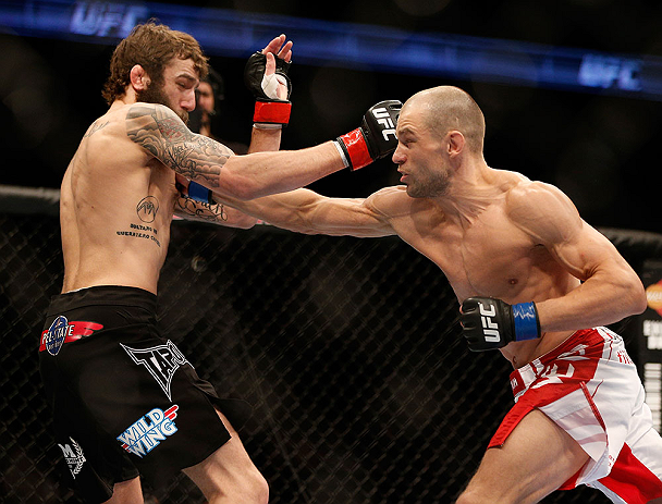 ANAHEIM, CA - FEBRUARY 23: (R-L) Anton Kuivanen punches Michael Chiesa in their lightweight bout during UFC 157 at Honda Center on February 23, 2013 in Anaheim, California. (Photo by Josh Hedges/Zuffa LLC/Zuffa LLC via Getty Images) *** Local Caption **
