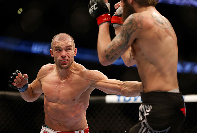 ANAHEIM, CA - FEBRUARY 23: (L-R) Anton Kuivanen punches Michael Chiesa in their lightweight bout during UFC 157 at Honda Center on February 23, 2013 in Anaheim, California. (Photo by Josh Hedges/Zuffa LLC/Zuffa LLC via Getty Images) *** Local Caption **