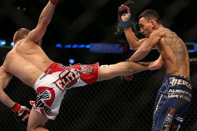 DENVER, CO - AUGUST 11: (L-R) Justin Lawrence kicks Max Holloway during their featherweight bout at UFC 150 inside Pepsi Center on August 11, 2012 in Denver, Colorado. (Photo by Josh Hedges/Zuffa LLC/Zuffa LLC via Getty Images)