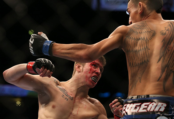 DENVER, CO - AUGUST 11: (L-R) Justin Lawrence and Max Holloway trade punches during their featherweight bout at UFC 150 inside Pepsi Center on August 11, 2012 in Denver, Colorado. (Photo by Josh Hedges/Zuffa LLC/Zuffa LLC via Getty Images)