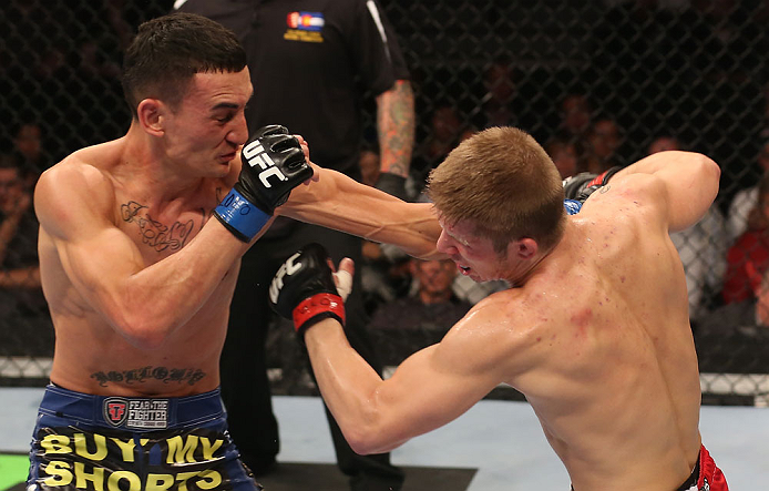 DENVER, CO - AUGUST 11: (L-R) Max Holloway punches Justin Lawrence during their featherweight bout at UFC 150 inside Pepsi Center on August 11, 2012 in Denver, Colorado. (Photo by Nick Laham/Zuffa LLC/Zuffa LLC via Getty Images)