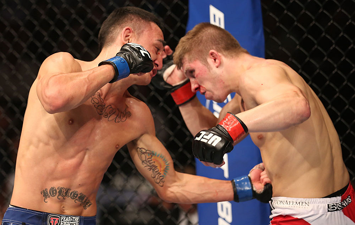DENVER, CO - AUGUST 11: (L-R) Max Holloway punches Justin Lawrence during their featherweight bout at UFC 150 inside Pepsi Center on August 11, 2012 in Denver, Colorado. (Photo by Nick Laham/Zuffa LLC/Zuffa LLC via Getty Images)
