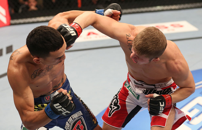 DENVER, CO - AUGUST 11: (R-L) Justin Lawrence punches Max Holloway during their featherweight bout at UFC 150 inside Pepsi Center on August 11, 2012 in Denver, Colorado. (Photo by Nick Laham/Zuffa LLC/Zuffa LLC via Getty Images)
