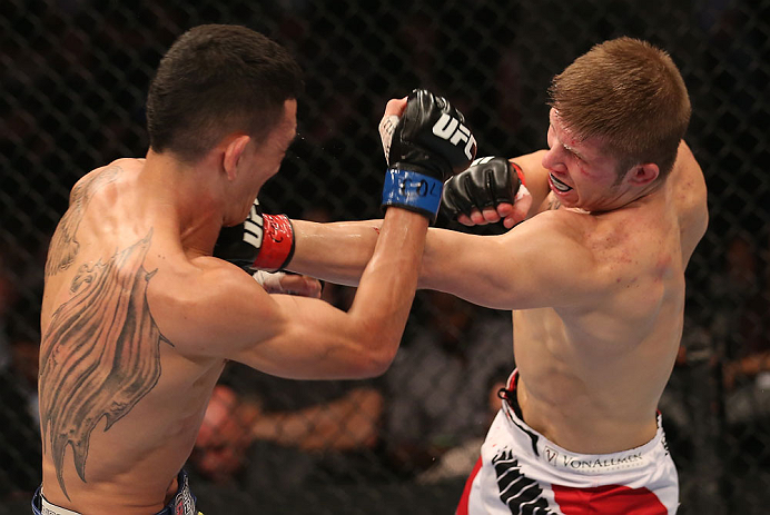 DENVER, CO - AUGUST 11: (L-R) Justin Lawrence punches Max Holloway during their featherweight bout at UFC 150 inside Pepsi Center on August 11, 2012 in Denver, Colorado. (Photo by Nick Laham/Zuffa LLC/Zuffa LLC via Getty Images)