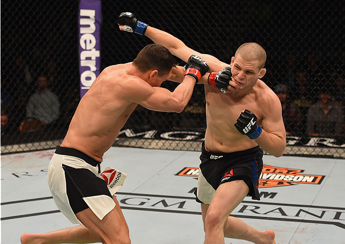 LAS VEGAS, NV - JANUARY 02: (R-L) Alex Morono punches Kyle Noke of Australia in their welterweight bout during the UFC 195 event inside MGM Grand Garden Arena on January 2, 2016 in Las Vegas, Nevada. (Photo by Josh Hedges/Zuffa LLC/Zuffa LLC via Getty Im