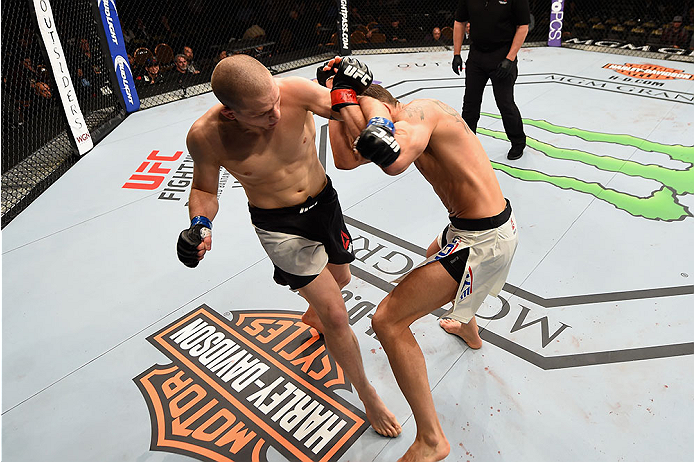 LAS VEGAS, NV - JANUARY 02: (L-R) Alex Morono punches Kyle Noke of Australia in their welterweight bout during the UFC 195 event inside MGM Grand Garden Arena on January 2, 2016 in Las Vegas, Nevada. (Photo by Josh Hedges/Zuffa LLC/Zuffa LLC via Getty Im