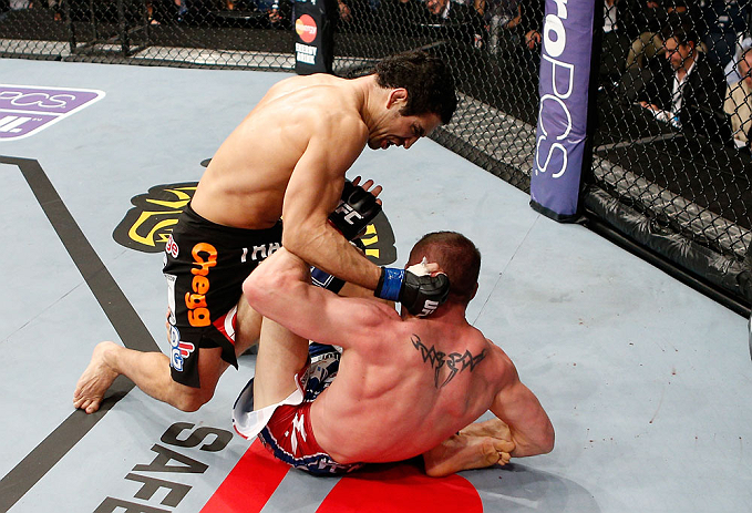 LONDON, ENGLAND - FEBRUARY 16: (L-R) Danny Castillo punches Paul Sass in their lightweight fight during the UFC on Fuel TV event on February 16, 2013 at Wembley Arena in London, England. (Photo by Josh Hedges/Zuffa LLC/Zuffa LLC via Getty Images)