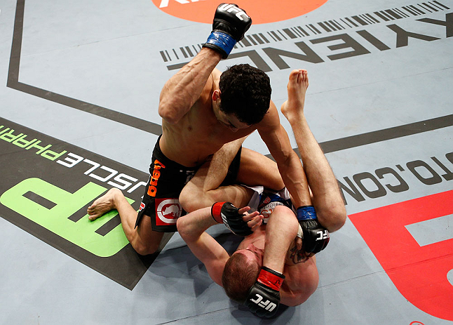 LONDON, ENGLAND - FEBRUARY 16: (L-R) Danny Castillo punches Paul Sass in their lightweight fight during the UFC on Fuel TV event on February 16, 2013 at Wembley Arena in London, England. (Photo by Josh Hedges/Zuffa LLC/Zuffa LLC via Getty Images)