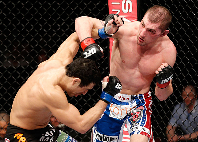 LONDON, ENGLAND - FEBRUARY 16: (R-L) Paul Sass punches Danny Castillo in their lightweight fight during the UFC on Fuel TV event on February 16, 2013 at Wembley Arena in London, England. (Photo by Josh Hedges/Zuffa LLC/Zuffa LLC via Getty Images)