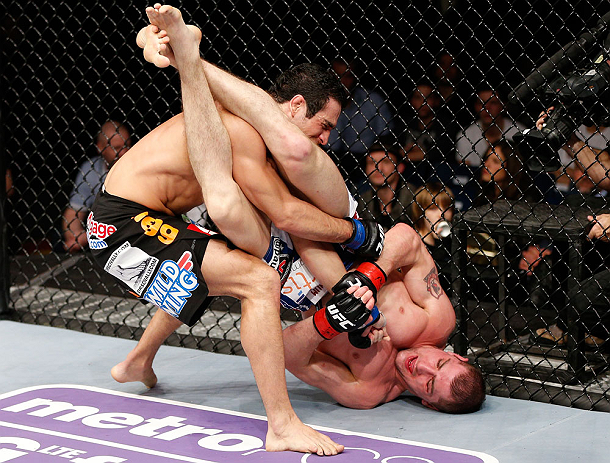 LONDON, ENGLAND - FEBRUARY 16: (R-L) Paul Sass attempts an arm bar submission against Danny Castillo in their lightweight fight during the UFC on Fuel TV event on February 16, 2013 at Wembley Arena in London, England. (Photo by Josh Hedges/Zuffa LLC/Zuf