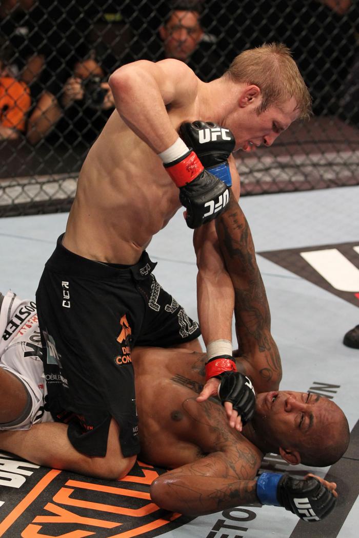 OMAHA, NE - FEBRUARY 15: TJ Dillashaw punches down at Walel Watson on the ground during the UFC on FUEL TV event at Omaha Civic Auditorium on February 15, 2012 in Omaha, Nebraska. (Photo by Josh Hedges/Zuffa LLC/Zuffa LLC via Getty Images) *** Local Cap