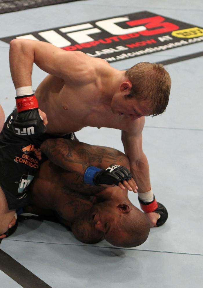 OMAHA, NE - FEBRUARY 15: TJ Dillashaw punches down at Walel Watson on the ground during the UFC on FUEL TV event at Omaha Civic Auditorium on February 15, 2012 in Omaha, Nebraska. (Photo by Josh Hedges/Zuffa LLC/Zuffa LLC via Getty Images) *** Local Cap
