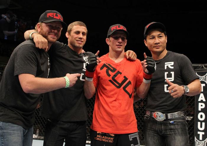OMAHA, NE - FEBRUARY 15: TJ Dillashaw (orange shirt) poses for a photo with his team after defeating Walel Watson during the UFC on FUEL TV event at Omaha Civic Auditorium on February 15, 2012 in Omaha, Nebraska. (Photo by Josh Hedges/Zuffa LLC/Zuffa LL