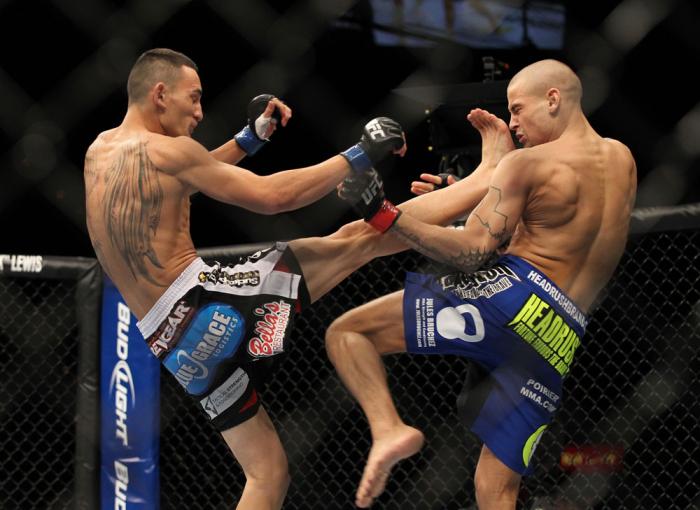 LAS VEGAS, NV - FEBRUARY 04: Max Holloway (left) kicks Dustin Poirier during the UFC 143 event at Mandalay Bay Events Center on February 4, 2012 in Las Vegas, Nevada. (Photo by Josh Hedges/Zuffa LLC/Zuffa LLC via Getty Images) *** Local Caption *** Max