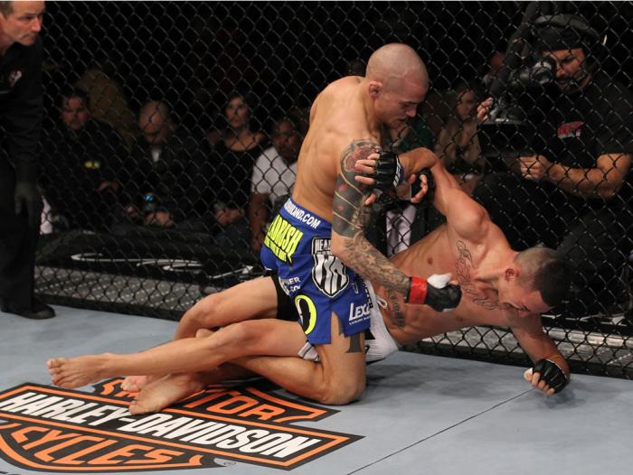 LAS VEGAS, NV - FEBRUARY 04: Dustin Poirier (blue shorts) delivers punches to Max Holloway from the mount during the UFC 143 event at Mandalay Bay Events Center on February 4, 2012 in Las Vegas, Nevada. (Photo by Nick Laham/Zuffa LLC/Zuffa LLC via Getty