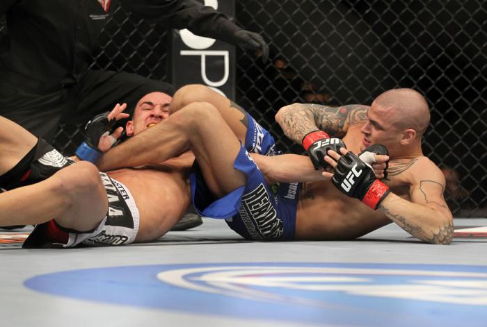 LAS VEGAS, NV - FEBRUARY 04: Dustin Poirier (blue shorts) attempts to submit Max Holloway during the UFC 143 event at Mandalay Bay Events Center on February 4, 2012 in Las Vegas, Nevada. (Photo by Josh Hedges/Zuffa LLC/Zuffa LLC via Getty Images) *** Lo