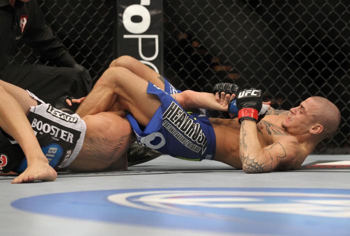 LAS VEGAS, NV - FEBRUARY 04: Dustin Poirier (blue shorts) attempts to submit Max Holloway during the UFC 143 event at Mandalay Bay Events Center on February 4, 2012 in Las Vegas, Nevada. (Photo by Josh Hedges/Zuffa LLC/Zuffa LLC via Getty Images) *** Lo