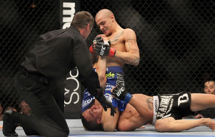 LAS VEGAS, NV - FEBRUARY 04: Dustin Poirier (blue shorts) attempts to submit Max Holloway during the UFC 143 event at Mandalay Bay Events Center on February 4, 2012 in Las Vegas, Nevada. (Photo by Josh Hedges/Zuffa LLC/Zuffa LLC via Getty Images) *** Lo