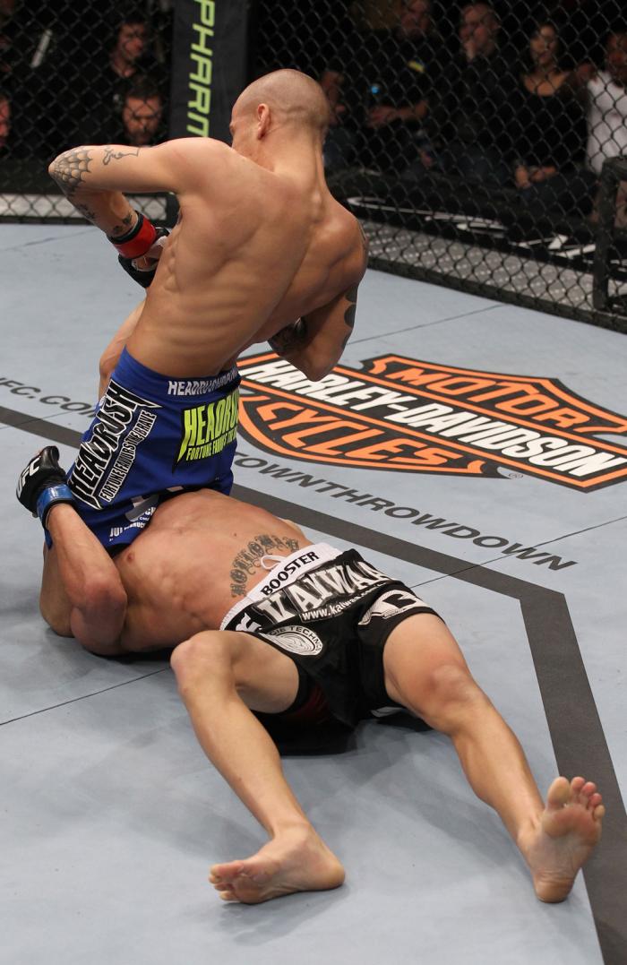 LAS VEGAS, NV - FEBRUARY 04: Dustin Poirier (blue shorts) attempts to submit Max Holloway during the UFC 143 event at Mandalay Bay Events Center on February 4, 2012 in Las Vegas, Nevada. (Photo by Nick Laham/Zuffa LLC/Zuffa LLC via Getty Images) *** Loc