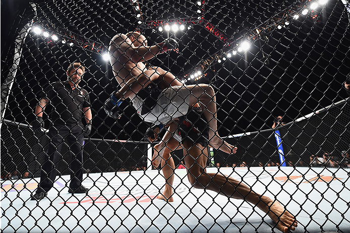 LAS VEGAS, NV - JANUARY 02: Masanori Kanehara of Japan (black trunks) takes down Michael McDonald in their bantamweight bout during the UFC 195 event inside MGM Grand Garden Arena on January 2, 2016 in Las Vegas, Nevada. (Photo by Jeff Bottari/Zuffa LLC/