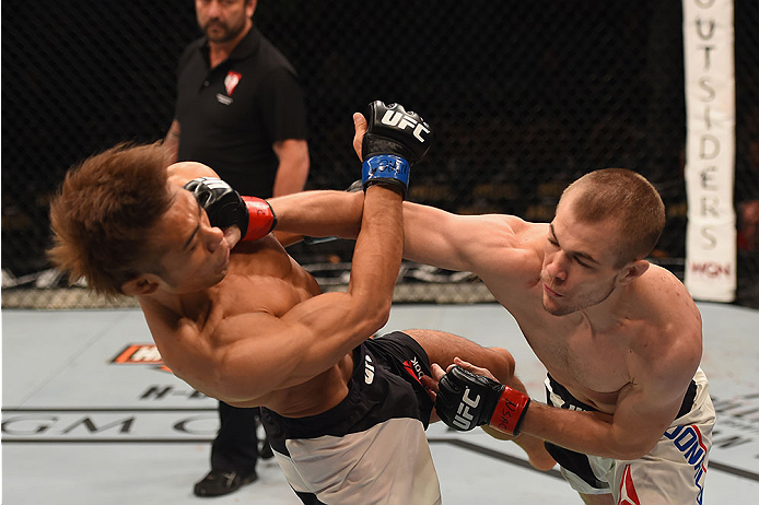 LAS VEGAS, NV - JANUARY 02: (R-L) Michael McDonald punches Masanori Kanehara of Japan in their bantamweight bout during the UFC 195 event inside MGM Grand Garden Arena on January 2, 2016 in Las Vegas, Nevada. (Photo by Josh Hedges/Zuffa LLC/Zuffa LLC vi