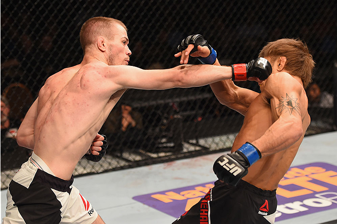 LAS VEGAS, NV - JANUARY 02: (L-R) Michael McDonald punches Masanori Kanehara of Japan in their bantamweight bout during the UFC 195 event inside MGM Grand Garden Arena on January 2, 2016 in Las Vegas, Nevada. (Photo by Josh Hedges/Zuffa LLC/Zuffa LLC via