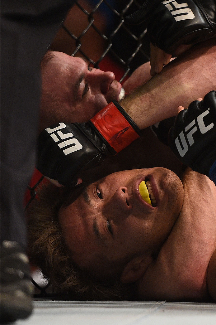 LAS VEGAS, NV - JANUARY 02: Michael McDonald (top) attempts to submit Masanori Kanehara of Japan in their bantamweight bout during the UFC 195 event inside MGM Grand Garden Arena on January 2, 2016 in Las Vegas, Nevada. (Photo by Jeff Bottari/Zuffa LLC/Z