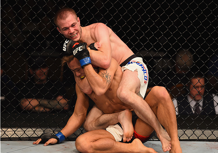 LAS VEGAS, NV - JANUARY 02: Michael McDonald (top) attempts to submit Masanori Kanehara of Japan in their bantamweight bout during the UFC 195 event inside MGM Grand Garden Arena on January 2, 2016 in Las Vegas, Nevada. (Photo by Josh Hedges/Zuffa LLC/Z