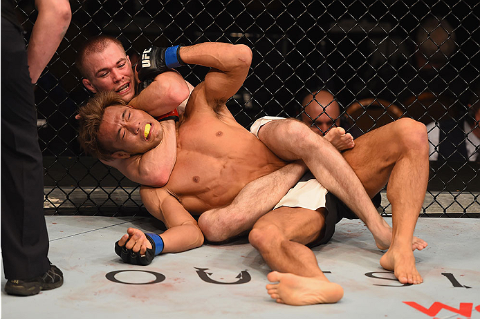 LAS VEGAS, NV - JANUARY 02: Michael McDonald (top) attempts to submit Masanori Kanehara of Japan in their bantamweight bout during the UFC 195 event inside MGM Grand Garden Arena on January 2, 2016 in Las Vegas, Nevada. (Photo by Josh Hedges/Zuffa LLC/Z