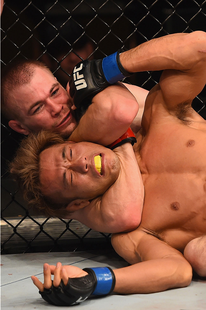 LAS VEGAS, NV - JANUARY 02: Michael McDonald (top) attempts to submit Masanori Kanehara of Japan in their bantamweight bout during the UFC 195 event inside MGM Grand Garden Arena on January 2, 2016 in Las Vegas, Nevada. (Photo by Josh Hedges/Zuffa LLC/Z
