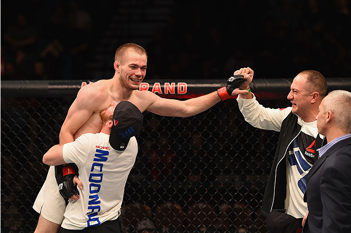 LAS VEGAS, NV - JANUARY 02: Michael McDonald (left) reacts to his victory over Masanori Kanehara of Japan in their bantamweight bout during the UFC 195 event inside MGM Grand Garden Arena on January 2, 2016 in Las Vegas, Nevada. (Photo by Josh Hedges/Zuf