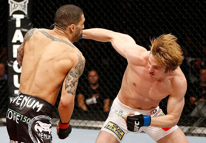 LONDON, ENGLAND - FEBRUARY 16: (R-L) Matthew Riddle punches Che Mills in their welterweight fight during the UFC on Fuel TV event on February 16, 2013 at Wembley Arena in London, England. (Photo by Josh Hedges/Zuffa LLC/Zuffa LLC via Getty Images)