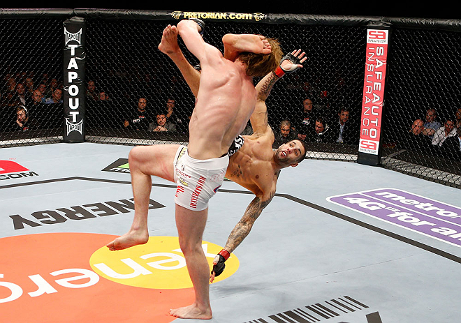 LONDON, ENGLAND - FEBRUARY 16: (R-L) Che Mills kicks Matthew Riddle after a takedown in their welterweight fight during the UFC on Fuel TV event on February 16, 2013 at Wembley Arena in London, England. (Photo by Josh Hedges/Zuffa LLC/Zuffa LLC via Gett