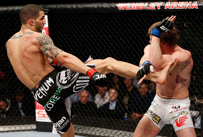 LONDON, ENGLAND - FEBRUARY 16: (L-R) Che Mills kicks Matthew Riddle in their welterweight fight during the UFC on Fuel TV event on February 16, 2013 at Wembley Arena in London, England. (Photo by Josh Hedges/Zuffa LLC/Zuffa LLC via Getty Images)