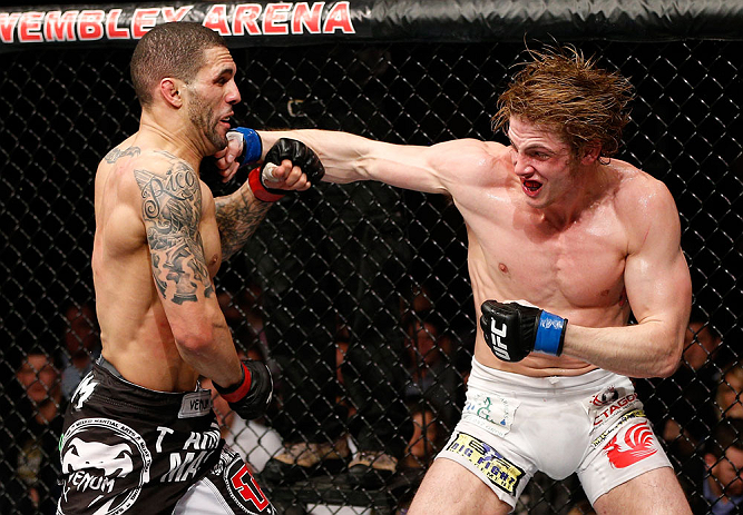 LONDON, ENGLAND - FEBRUARY 16: (R-L) Matthew Riddle punches Che Mills in their welterweight fight during the UFC on Fuel TV event on February 16, 2013 at Wembley Arena in London, England. (Photo by Josh Hedges/Zuffa LLC/Zuffa LLC via Getty Images)