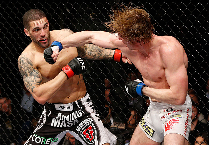 LONDON, ENGLAND - FEBRUARY 16: (R-L) Matthew Riddle punches Che Mills in their welterweight fight during the UFC on Fuel TV event on February 16, 2013 at Wembley Arena in London, England. (Photo by Josh Hedges/Zuffa LLC/Zuffa LLC via Getty Images)