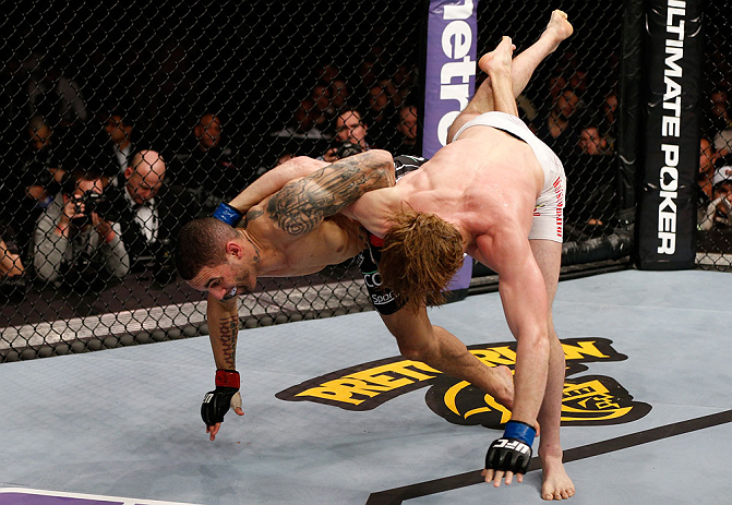 LONDON, ENGLAND - FEBRUARY 16: (L-R) Che Mills attempts to throw Matthew Riddle to the mat in their welterweight fight during the UFC on Fuel TV event on February 16, 2013 at Wembley Arena in London, England. (Photo by Josh Hedges/Zuffa LLC/Zuffa LLC vi