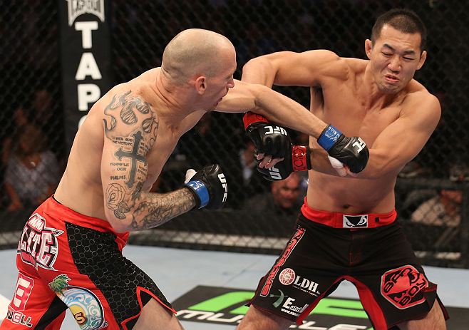 DENVER, CO - AUGUST 11: (L-R) Buddy Roberts punches Yushin Okami during their middleweight bout at UFC 150 inside Pepsi Center on August 11, 2012 in Denver, Colorado. (Photo by Nick Laham/Zuffa LLC/Zuffa LLC via Getty Images)