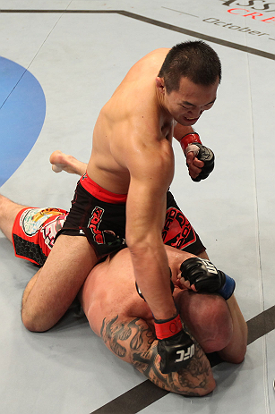 DENVER, CO - AUGUST 11: Yushin Okami (top) punches down at Buddy Roberts during their middleweight bout at UFC 150 inside Pepsi Center on August 11, 2012 in Denver, Colorado. (Photo by Nick Laham/Zuffa LLC/Zuffa LLC via Getty Images)