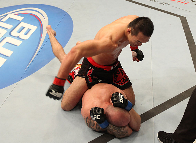 DENVER, CO - AUGUST 11: Yushin Okami (top) punches down at Buddy Roberts during their middleweight bout at UFC 150 inside Pepsi Center on August 11, 2012 in Denver, Colorado. (Photo by Nick Laham/Zuffa LLC/Zuffa LLC via Getty Images)