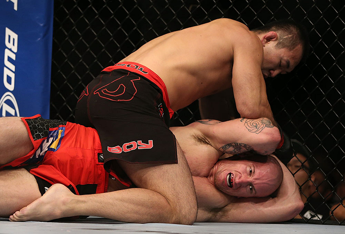 DENVER, CO - AUGUST 11: Yushin Okami (top) punches down at Buddy Roberts during their middleweight bout at UFC 150 inside Pepsi Center on August 11, 2012 in Denver, Colorado. (Photo by Josh Hedges/Zuffa LLC/Zuffa LLC via Getty Images)