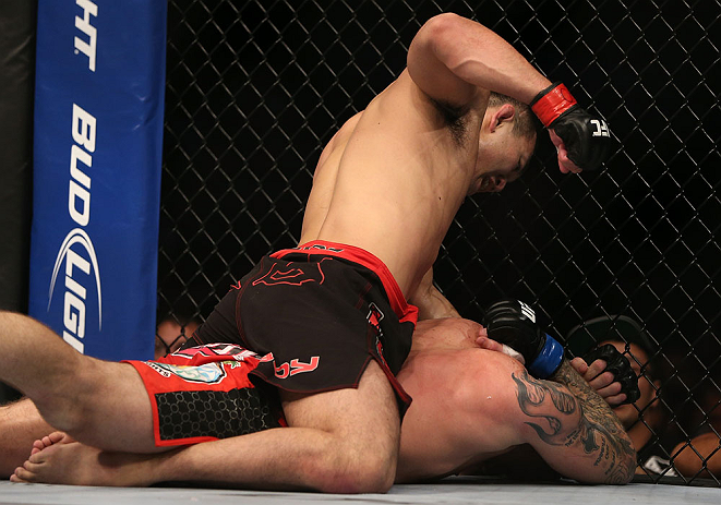 DENVER, CO - AUGUST 11: Yushin Okami (top) punches down at Buddy Roberts during their middleweight bout at UFC 150 inside Pepsi Center on August 11, 2012 in Denver, Colorado. (Photo by Josh Hedges/Zuffa LLC/Zuffa LLC via Getty Images)