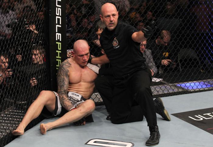 TORONTO, ON - DECEMBER 10: (R-L) Referee Yves Lavigne calls for a doctor after Krzysztof Soszynski was knocked out by Igor Pokrajac during the UFC 140 event at Air Canada Centre on December 10, 2011 in Toronto, Ontario, Canada. (Photo by Nick Laham/Zuff