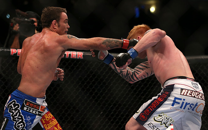 DENVER, CO - AUGUST 11: (L-R) Jake Shields punches Ed Herman during their middleweight bout at UFC 150 inside Pepsi Center on August 11, 2012 in Denver, Colorado. (Photo by Josh Hedges/Zuffa LLC/Zuffa LLC via Getty Images)