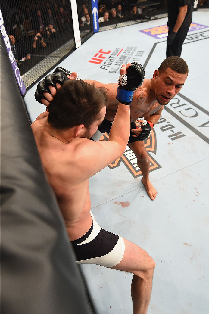 LAS VEGAS, NV - JANUARY 02: (R-L) Abel Trujillo punches Tony Sims in their lightweight bout during the UFC 195 event inside MGM Grand Garden Arena on January 2, 2016 in Las Vegas, Nevada. (Photo by Josh Hedges/Zuffa LLC/Zuffa LLC via Getty Images)