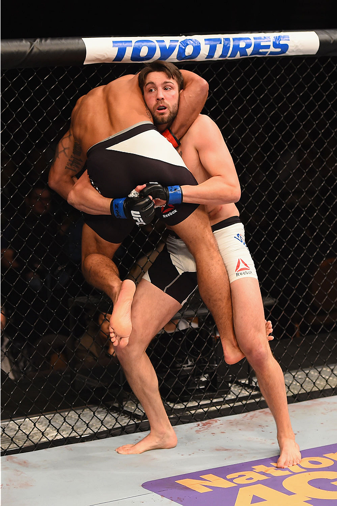LAS VEGAS, NV - JANUARY 02: Tony Sims (white trunks) lifts up Abel Trujillo in their lightweight bout during the UFC 195 event inside MGM Grand Garden Arena on January 2, 2016 in Las Vegas, Nevada. (Photo by Josh Hedges/Zuffa LLC/Zuffa LLC via Getty Imag